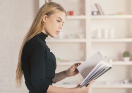 Attractive european female reading notes in diary